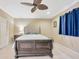 Bedroom featuring a ceiling fan, carpeted floor, and a sleigh bed at 23320 Dinhurst Ct, Land O Lakes, FL 34639