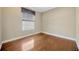 Bedroom with hardwood floors and a window with blinds at 23320 Dinhurst Ct, Land O Lakes, FL 34639