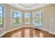 Bright breakfast nook with hardwood floors and windows offering pool and golf course views at 23320 Dinhurst Ct, Land O Lakes, FL 34639