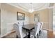 Formal dining area featuring hardwood floors, neutral walls, a chandelier and a table for six at 23320 Dinhurst Ct, Land O Lakes, FL 34639