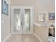 Elegant entryway with decorative glass double doors, neutral walls and tile flooring at 23320 Dinhurst Ct, Land O Lakes, FL 34639