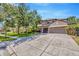 Beautiful two-story home with a three-car garage, well-maintained landscaping and a large driveway at 23320 Dinhurst Ct, Land O Lakes, FL 34639