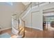 Grand foyer featuring a curved staircase, hardwood floors, and natural light at 23320 Dinhurst Ct, Land O Lakes, FL 34639