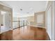 Upstairs hallway showcasing hardwood floors and a view of the foyer below at 23320 Dinhurst Ct, Land O Lakes, FL 34639