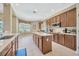 Large kitchen with central island, stainless steel appliances, tile flooring, and wood cabinets at 23320 Dinhurst Ct, Land O Lakes, FL 34639