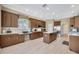 Spacious kitchen with wooden cabinets, white countertops, tile floor, and stainless steel appliances at 23320 Dinhurst Ct, Land O Lakes, FL 34639
