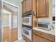 Kitchen with double ovens, wooden cabinets and drawers, with quartz countertops at 23320 Dinhurst Ct, Land O Lakes, FL 34639