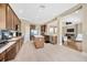 Modern kitchen with an island, stainless steel appliances, wooden cabinets, and tile floors at 23320 Dinhurst Ct, Land O Lakes, FL 34639