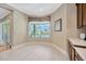 Bright kitchen nook with tile floor and a window overlooking the screened in pool at 23320 Dinhurst Ct, Land O Lakes, FL 34639