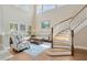Open living room featuring soaring ceilings, large windows, and hardwood flooring at 23320 Dinhurst Ct, Land O Lakes, FL 34639