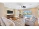 Spacious living room with a ceiling fan, access to the patio, and comfortable seating at 23320 Dinhurst Ct, Land O Lakes, FL 34639