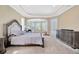 Main bedroom with tray ceilings, large windows and luxury furniture at 23320 Dinhurst Ct, Land O Lakes, FL 34639