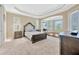 Main bedroom with tray ceilings, large windows and sitting area at 23320 Dinhurst Ct, Land O Lakes, FL 34639