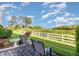 Backyard featuring a well-maintained lawn and scenic white fence view, ideal for outdoor activities at 2725 Terra Ceia Bay Blvd # 104, Palmetto, FL 34221
