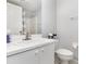 Well-lit bathroom featuring a white vanity, toilet, and shower with curtain at 2725 Terra Ceia Bay Blvd # 104, Palmetto, FL 34221