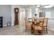 Bright dining area featuring a glass-top table, straw chairs, and wood-look flooring at 2725 Terra Ceia Bay Blvd # 104, Palmetto, FL 34221