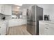 Modern kitchen featuring stainless steel appliances, white cabinets, and granite countertops at 2725 Terra Ceia Bay Blvd # 104, Palmetto, FL 34221