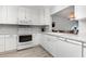 Updated kitchen with white cabinetry, granite counters, and a stainless steel sink at 2725 Terra Ceia Bay Blvd # 104, Palmetto, FL 34221