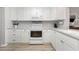 Well-lit kitchen featuring white cabinets, granite counters, and modern appliances at 2725 Terra Ceia Bay Blvd # 104, Palmetto, FL 34221