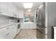 Contemporary kitchen boasting white cabinets, granite counters, and stainless steel refrigerator at 2725 Terra Ceia Bay Blvd # 104, Palmetto, FL 34221