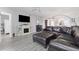 Bright living room with modern flooring, fireplace, large television, and leather furniture at 2725 Terra Ceia Bay Blvd # 104, Palmetto, FL 34221