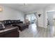 Comfortable living room with modern flooring, leather sectional, ceiling fan, and access to the lanai at 2725 Terra Ceia Bay Blvd # 104, Palmetto, FL 34221