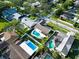 Aerial view of neighborhood showcasing community homes with well maintained yards and mature trees at 2897 Rosery Ne Rd, Largo, FL 33771