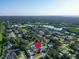 Aerial view with pin of home in a neighborhood close to a lake surrounded by green trees at 2897 Rosery Ne Rd, Largo, FL 33771