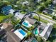Aerial view of home, marked with a black circle, and its neighborhood with lush greenery and nearby houses at 2897 Rosery Ne Rd, Largo, FL 33771