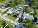 Aerial view of a residential area with well-maintained lawns and mature trees surrounding the homes at 2897 Rosery Ne Rd, Largo, FL 33771