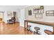 A bar area with high top seating, wood shelving, and wood flooring at 2897 Rosery Ne Rd, Largo, FL 33771