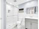 Modern bathroom with white tiled shower and gray vanity giving an updated look at 2897 Rosery Ne Rd, Largo, FL 33771
