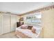 This bedroom is bright and has a daybed with wallpaper and a window at 2897 Rosery Ne Rd, Largo, FL 33771