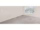 Neutral bedroom with carpet and a large window, ready for personalization at 2897 Rosery Ne Rd, Largo, FL 33771