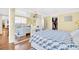 Comfortable bedroom featuring wood-look flooring, a bed with blue floral bedding, and a walk-in closet at 2897 Rosery Ne Rd, Largo, FL 33771