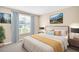 Comfortable bedroom featuring a queen bed, neutral walls, and large window at 2897 Rosery Ne Rd, Largo, FL 33771