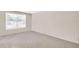 Bright bedroom with a large window bringing in lots of natural light and neutral carpet at 2897 Rosery Ne Rd, Largo, FL 33771