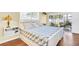 Comfortable bedroom featuring wood-look flooring, a bed with blue floral bedding, and a sliding door to the lanai at 2897 Rosery Ne Rd, Largo, FL 33771