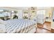 Comfortable bedroom featuring wood-look flooring, a bed with blue floral bedding, and a sliding door to the lanai at 2897 Rosery Ne Rd, Largo, FL 33771