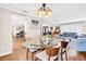 Well-lit dining room with a modern chandelier, hardwood floors, and an open layout at 2897 Rosery Ne Rd, Largo, FL 33771