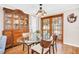 Charming dining room featuring a glass table, wooden chairs, and beautiful hardwood floors at 2897 Rosery Ne Rd, Largo, FL 33771