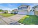 Charming two-story home boasts a well-manicured lawn, balcony, and an attached two-car garage at 2897 Rosery Ne Rd, Largo, FL 33771