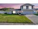 Charming two-story home features a well-manicured lawn, a balcony, and an attached two-car garage at 2897 Rosery Ne Rd, Largo, FL 33771