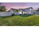 A beautiful suburban house boasts a lush green lawn, and a white fence, perfect for a tranquil Gathering lifestyle at 2897 Rosery Ne Rd, Largo, FL 33771