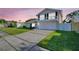 Charming home with a two-car garage, an upper balcony, and a well-manicured front lawn at 2897 Rosery Ne Rd, Largo, FL 33771