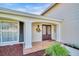 A welcoming covered entryway features double front doors and decorative wreath, next to a large bright window at 2897 Rosery Ne Rd, Largo, FL 33771