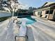 Backyard in-ground swimming pool featuring a diving board, ladder and outdoor seating at 2897 Rosery Ne Rd, Largo, FL 33771