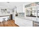 Open-concept kitchen with island seating, modern mosaic backsplash, and view to the sunroom at 2897 Rosery Ne Rd, Largo, FL 33771