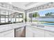 Kitchen sink with modern white cabinets and stainless steel appliances with a view of the pool at 2897 Rosery Ne Rd, Largo, FL 33771