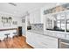 Modern kitchen with island seating, modern backsplash, and view to the sunroom at 2897 Rosery Ne Rd, Largo, FL 33771